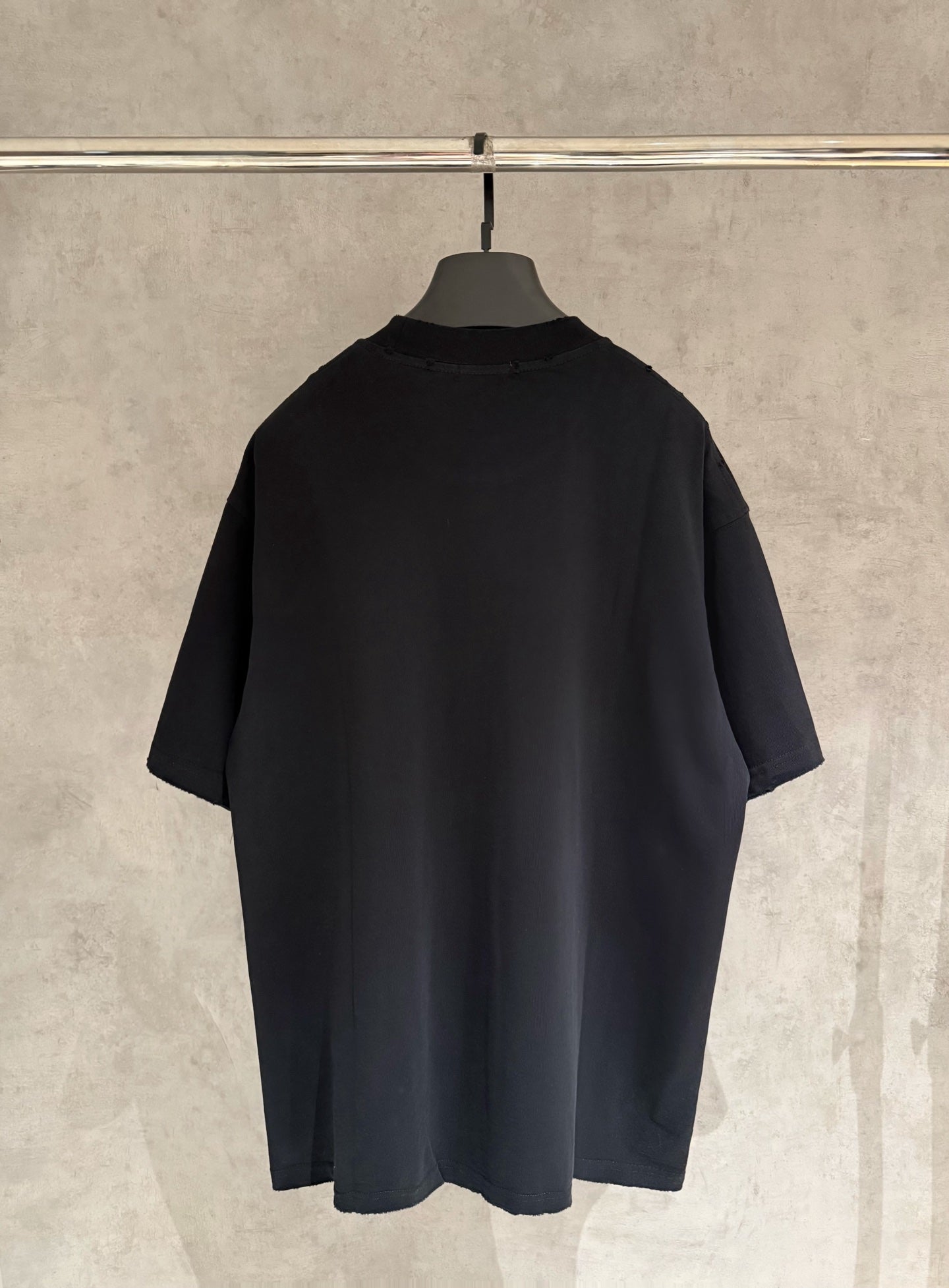 Black short-sleeve T-shirt, back view with relaxed fit.