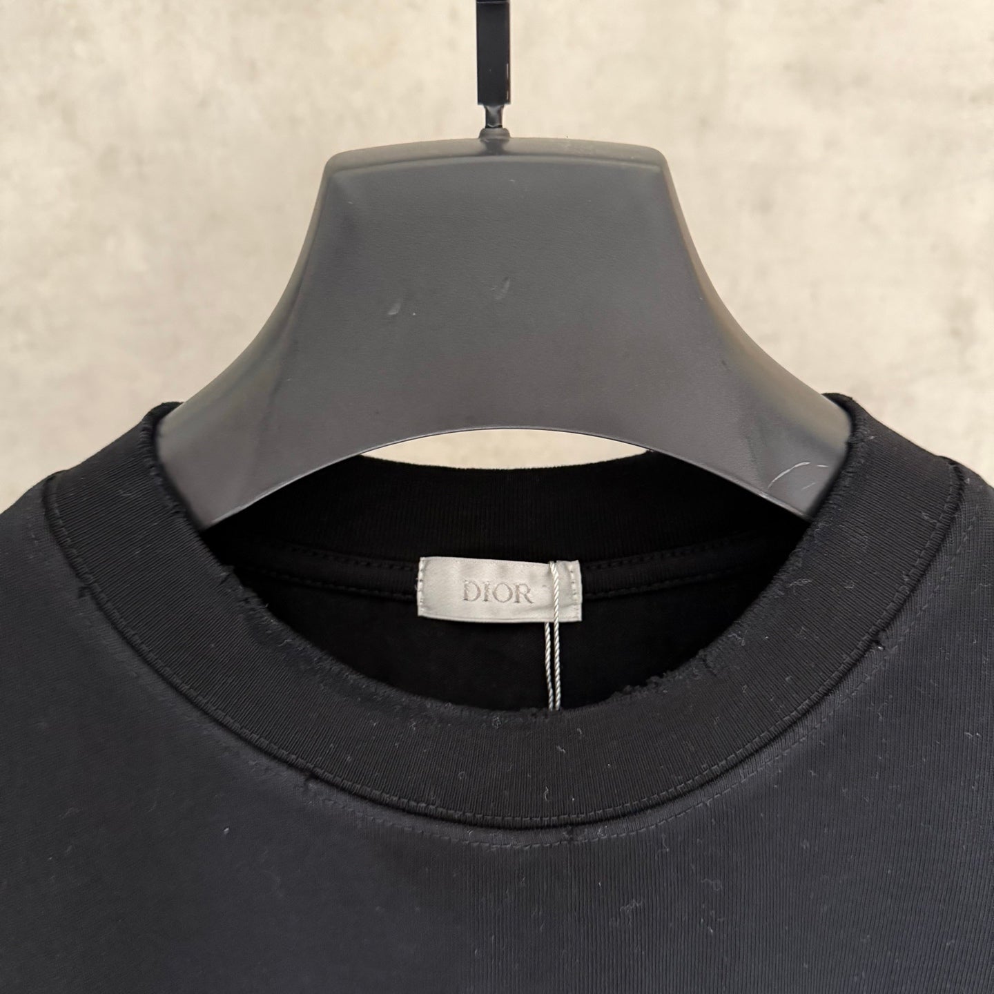 Black Dior short-sleeve T-shirt neckline label and ribbed crew collar.