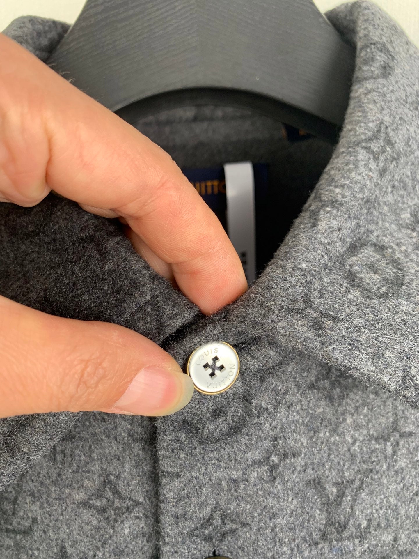 Monogram button-up shirt close-up of white button fastening