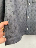 Monogram button-up shirt hem close-up with side panel and button detail