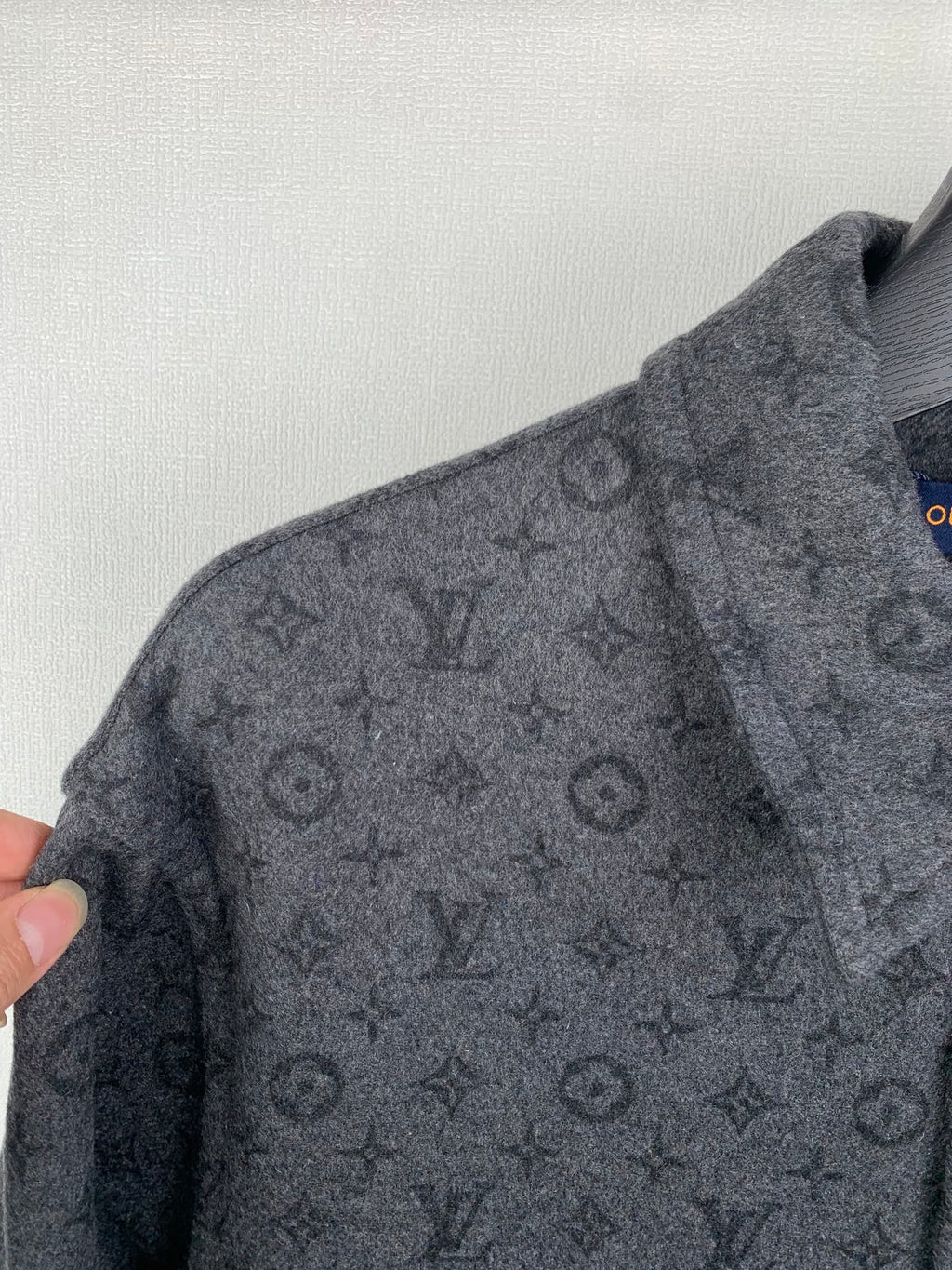 Monogram button-up shirt close-up of shoulder and sleeve with repeating pattern