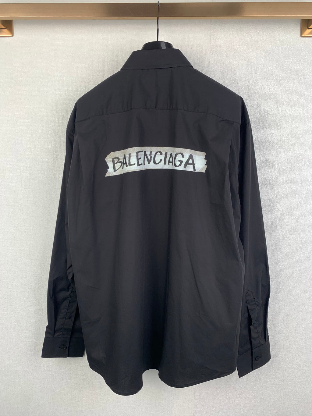 Long-sleeve button-up shirt, dark gray, back view with large logo print