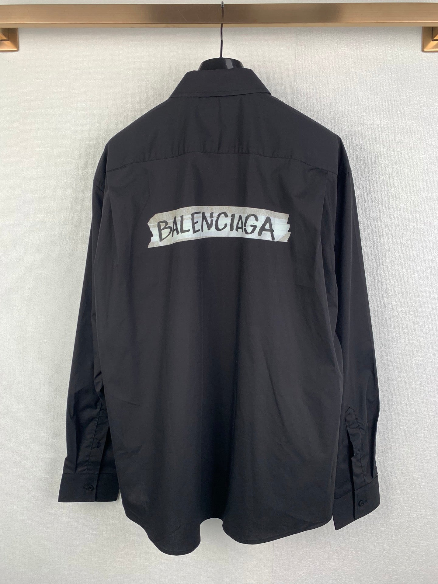 Long-sleeve button-up shirt, dark gray, back view with large logo print