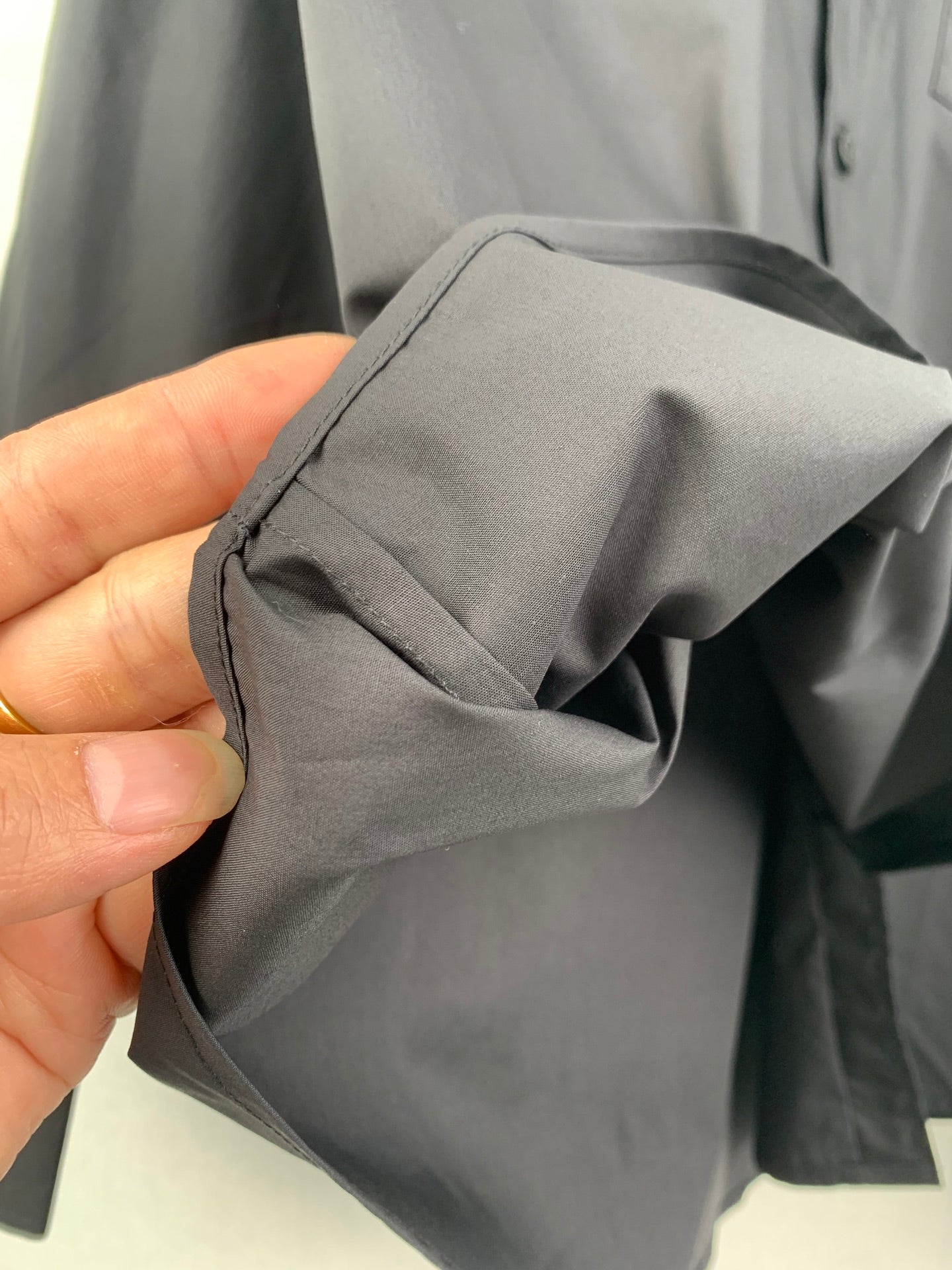Long-sleeve button-up shirt, gray, folded fabric with smooth drape texture