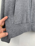 Gray hoodie hem and pocket area with ribbed bottom cuff