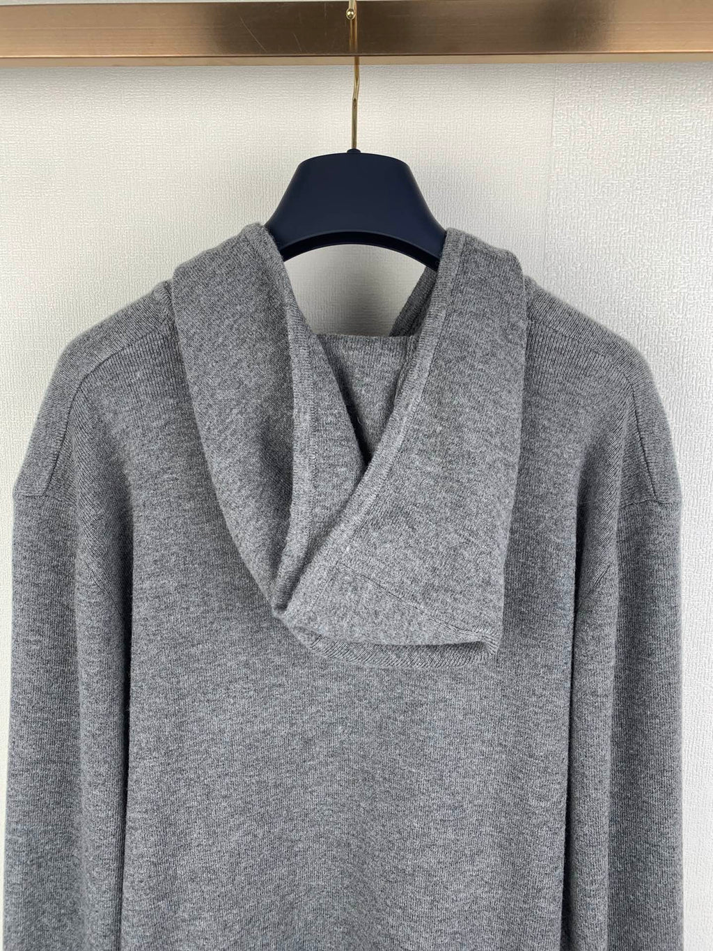Gray zip-up hoodie, close-up of hood and draped collar opening