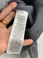 Gray hoodie fabric tag with size and material composition text