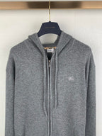 Gray zip-up hoodie with drawstring hood and small chest logo