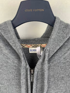 Gray hoodie neckline with inner hood label and metal zipper pull