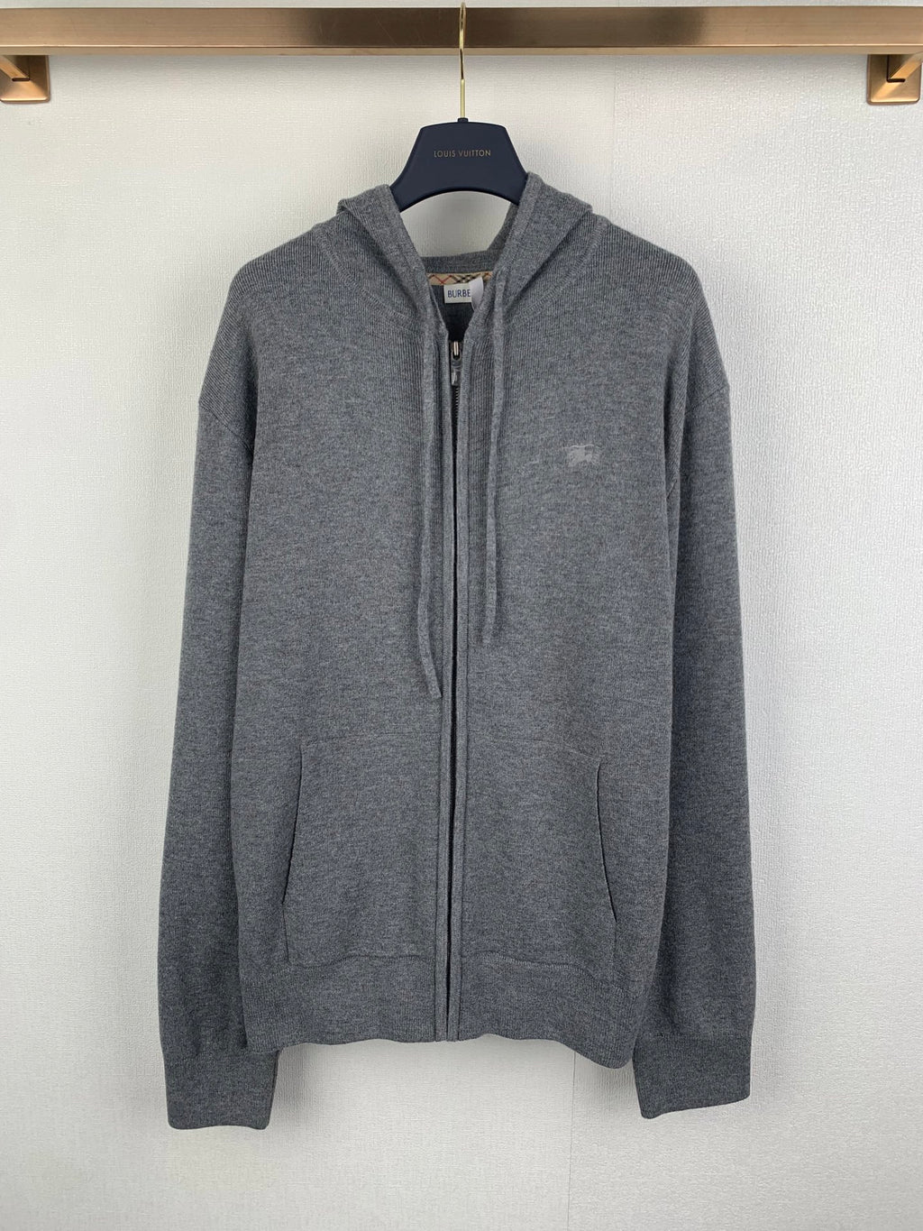 Gray zip-up hoodie with drawstring hood and front zipper