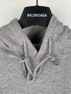Gray hoodie hood with white drawstrings and metal tips, Dior logo