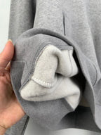 Gray hoodie cuff with brushed inner lining and stitched edge