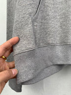 Gray hoodie front seam and pocket area, knit cuffs and hem