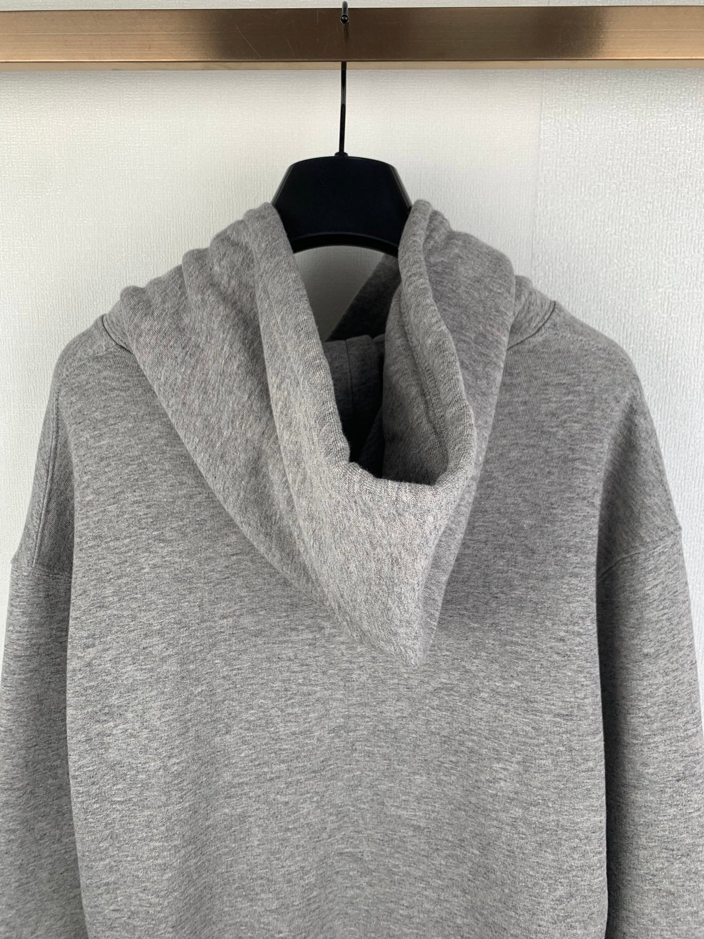 Gray pullover hoodie close-up of cowl hood and front pouch pocket