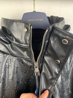 Long Louis Vuitton coat with black zip front, gold hardware, monogram-printed lining