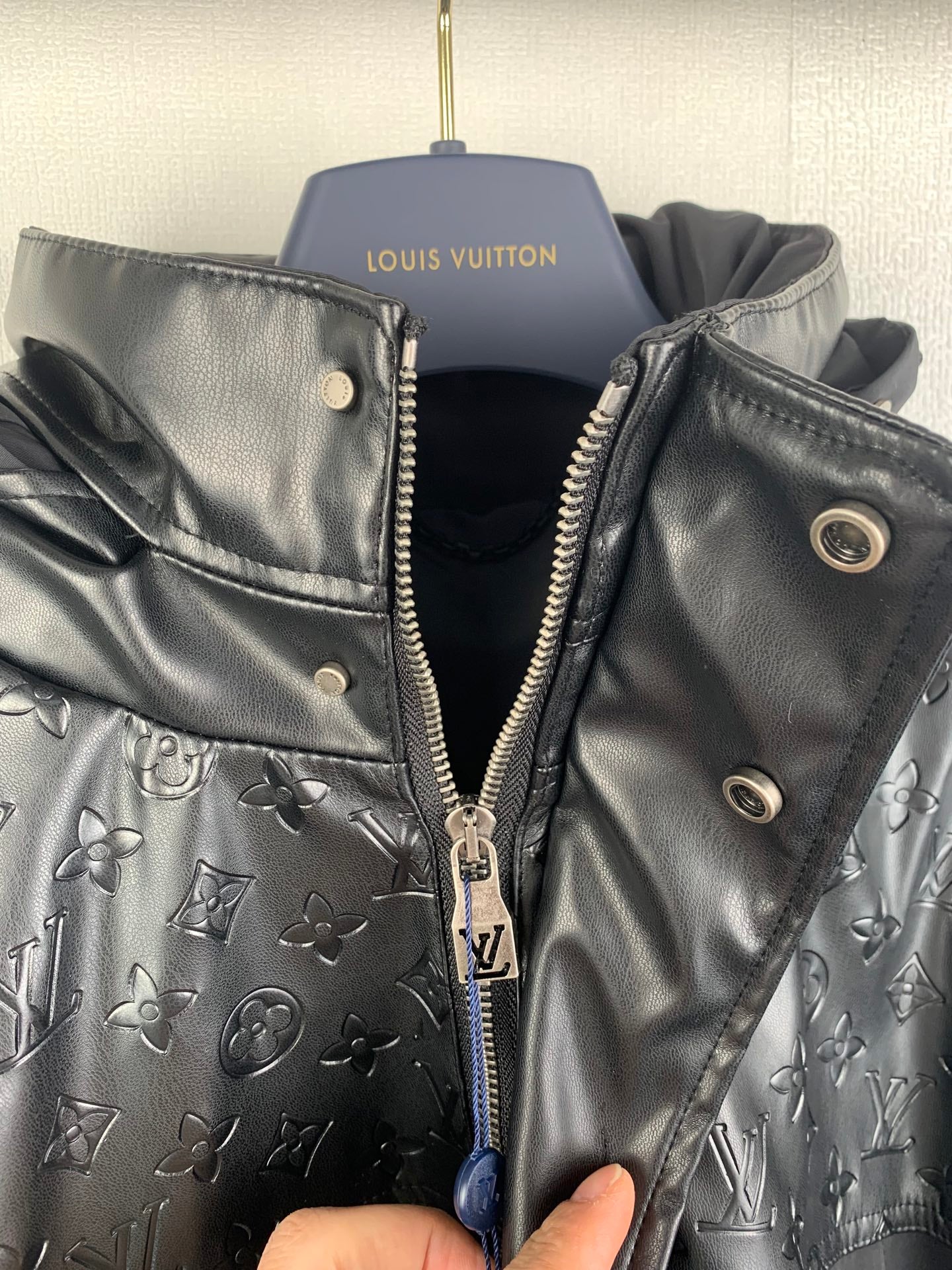 Long Louis Vuitton coat with black zip front, gold hardware, monogram-printed lining
