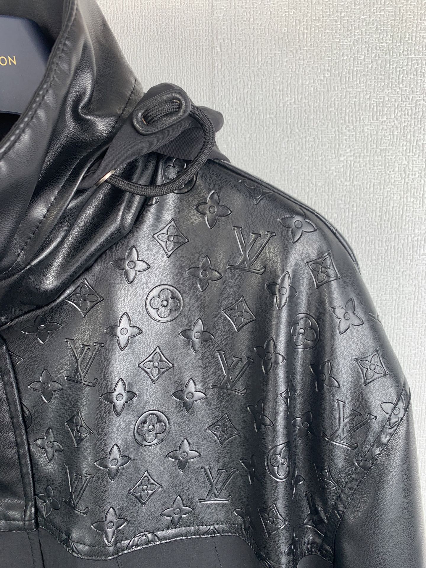 Louis Vuitton jacket sleeve with embossed monogram pattern and stitched detail