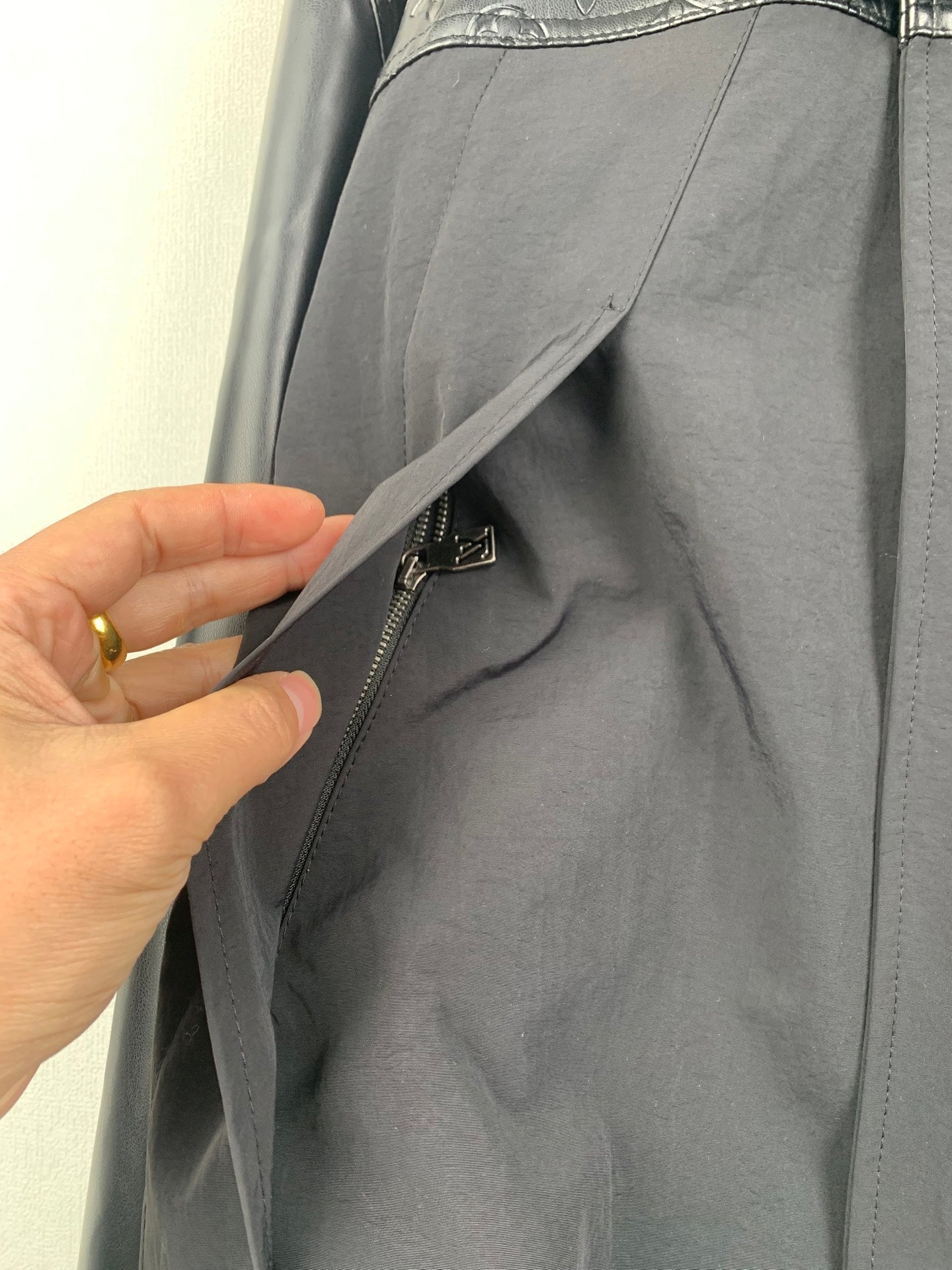 Louis Vuitton long jacket side panel with zipper pocket and snap tab detail
