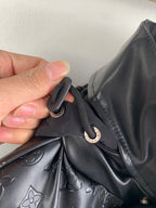 Louis Vuitton jacket collar with button closure and strap near logo pull tab