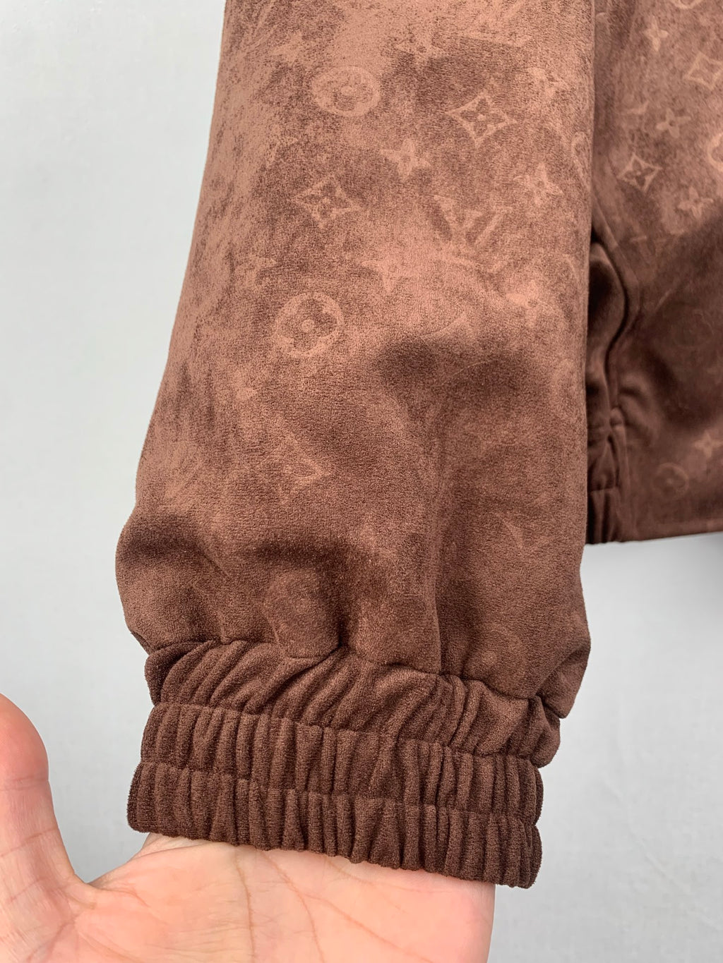 Dark brown monogram zip-up hooded jacket sleeve cuff with elastic ribbed trim
