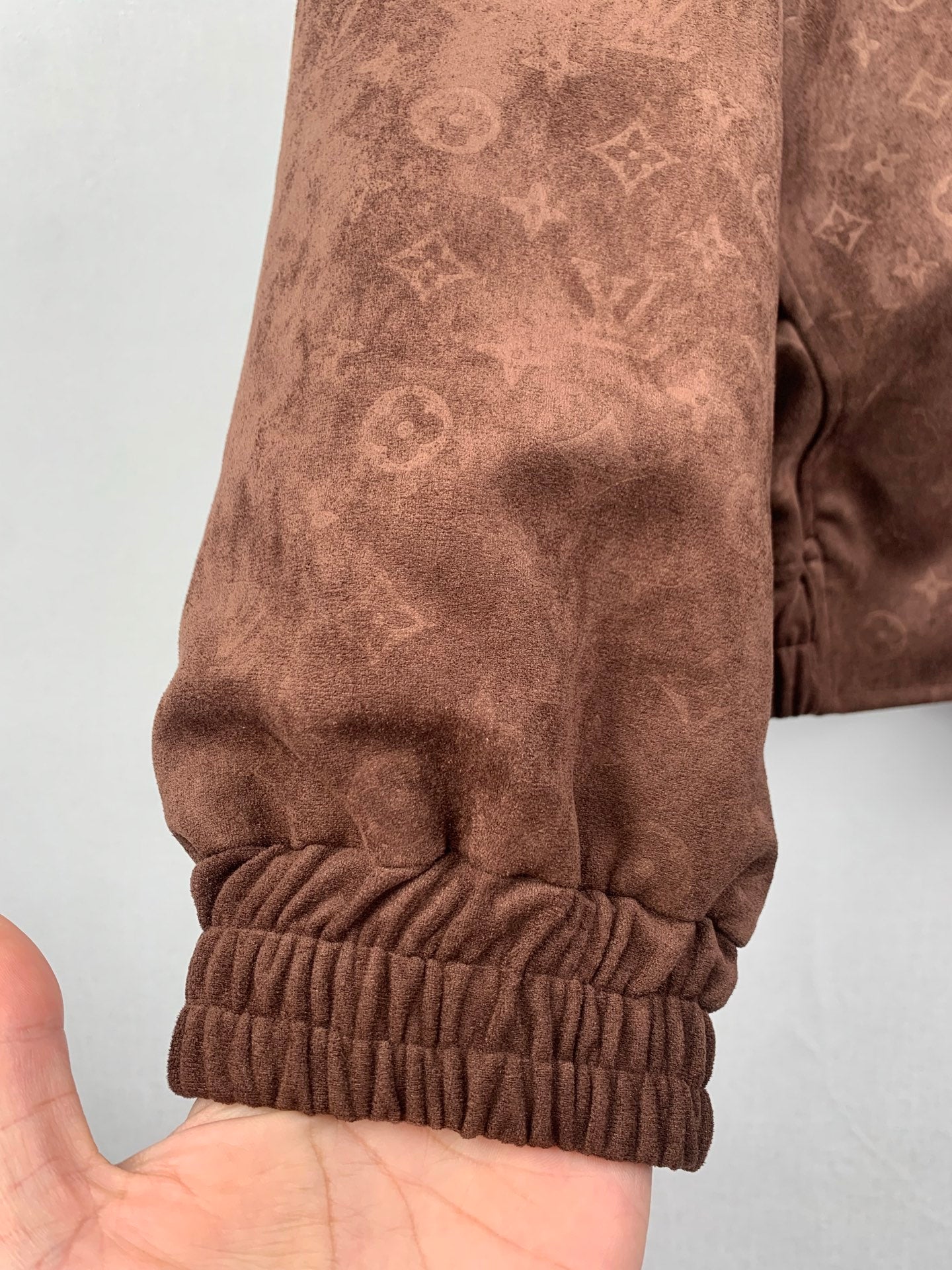 Dark brown monogram zip-up hooded jacket sleeve cuff with elastic ribbed trim