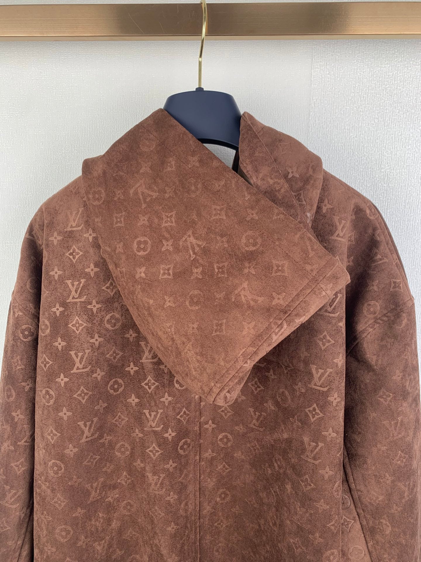 Dark brown monogram zip-up hooded jacket with structured hood and front zipper