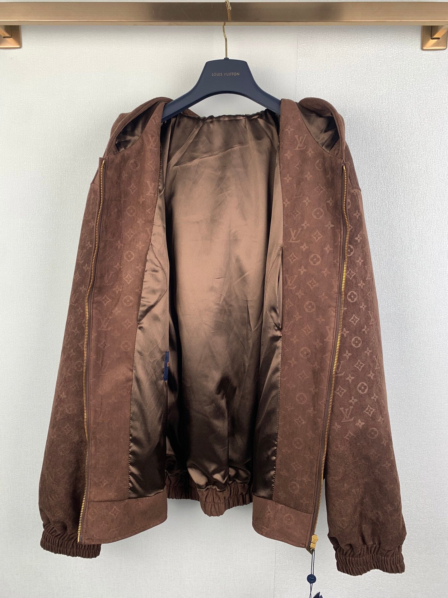 Dark brown monogram zip-up hooded jacket open at front, showing inner lining