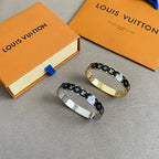 Louis Vuitton pair of monogram bangles, black with gold and silver bands