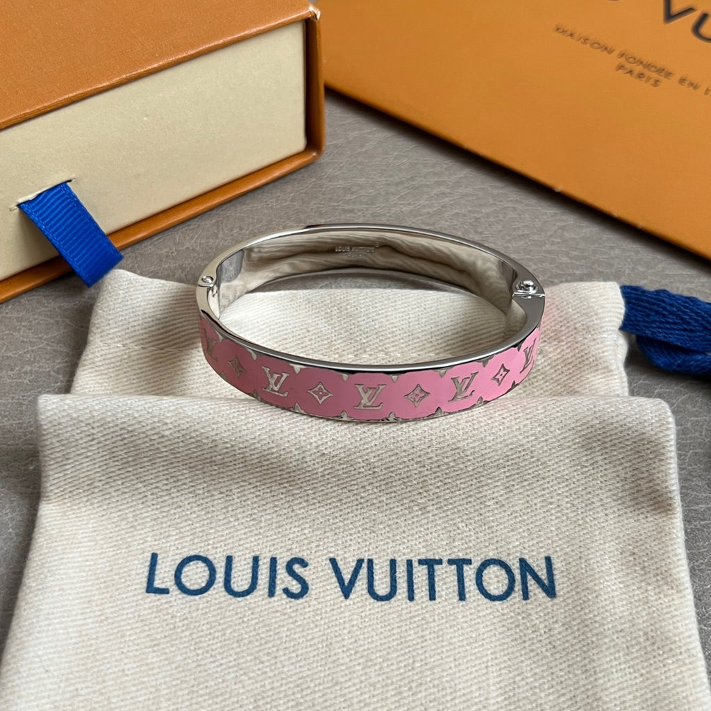 Pink monogram bangle bracelet with silver-tone metal cuff, on a white dust bag
