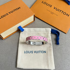 Pink monogram bangle bracelet with silver-tone metal cuff, on a white dust bag