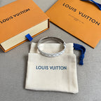Silver Louis Vuitton cuff bracelet with LV monogram pattern on white pouch
