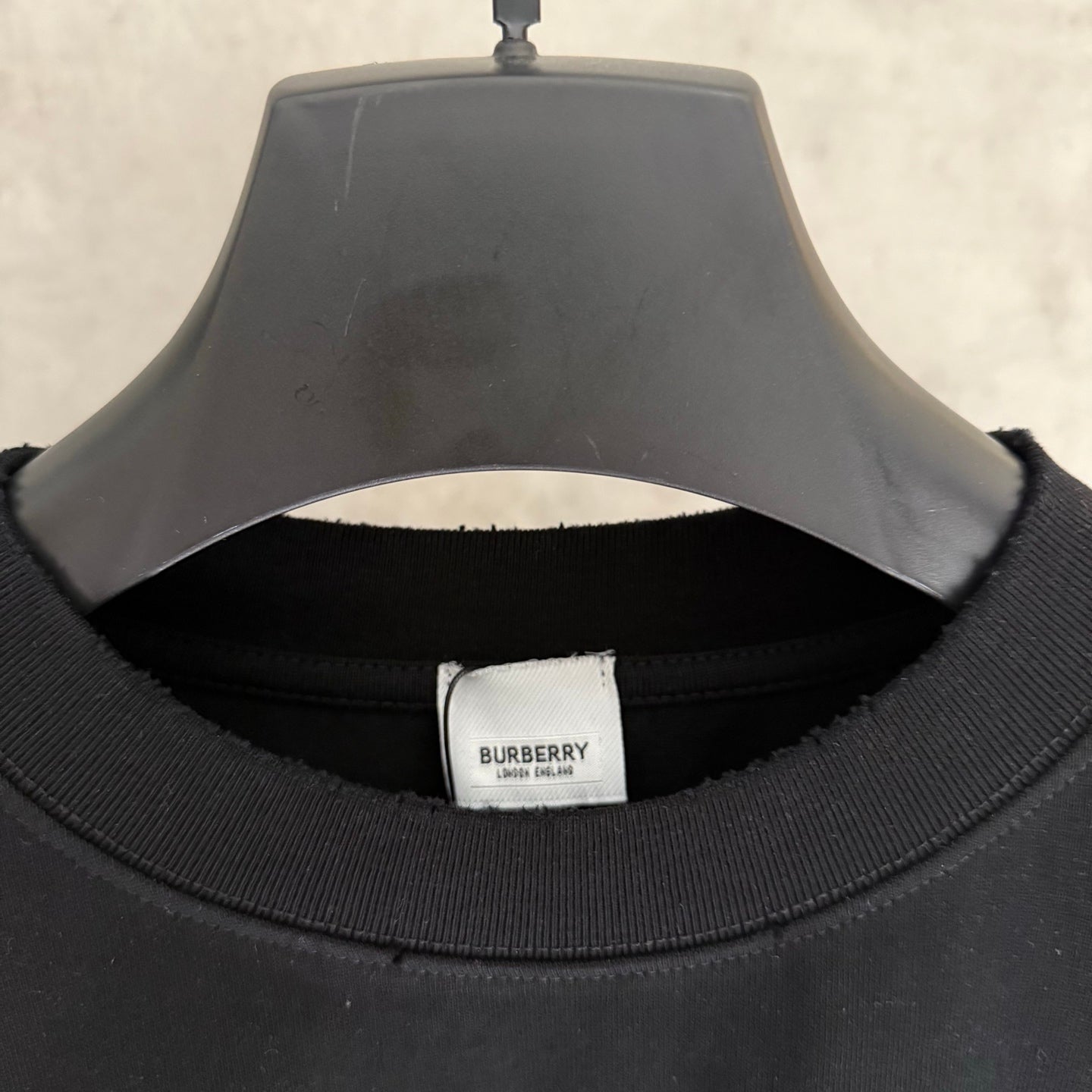 Black T-shirt neckline with Burberry logo label