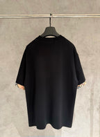 Black short-sleeve crewneck T-shirt, back view, with check-trim cuffs