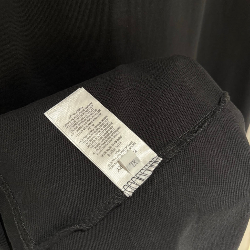 Black T-shirt with internal size and care label at sleeve