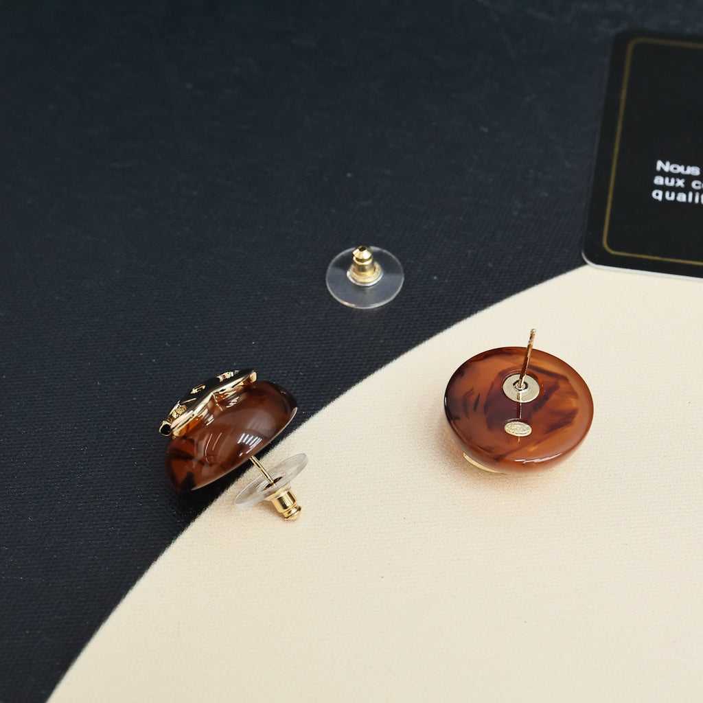 Brown round stud earrings with gold-tone backs and posts, pair displayed