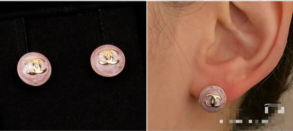 Chanel stud earrings on ear: round pink enamel with gold-tone CC logo