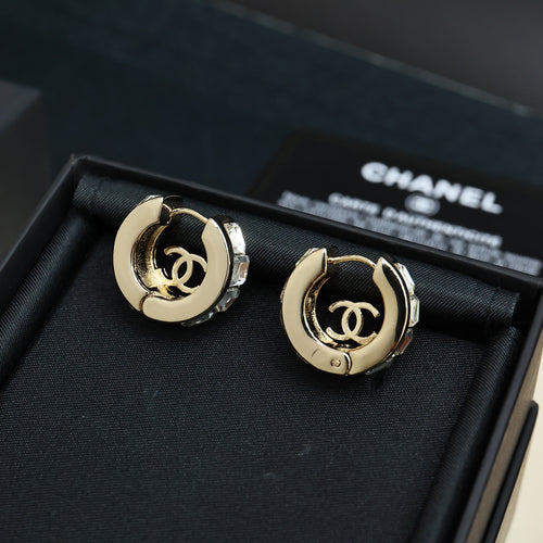 Pair of gold-tone hoop earrings with logo medallion and clear rhinestone details