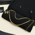Gold-tone Chanel logo link chain necklace on black pouch
