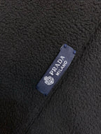 Prada Milano fabric label on dark textured fleece material