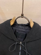 Prada hood lining detail with zipper and interior brand label, dark fabric