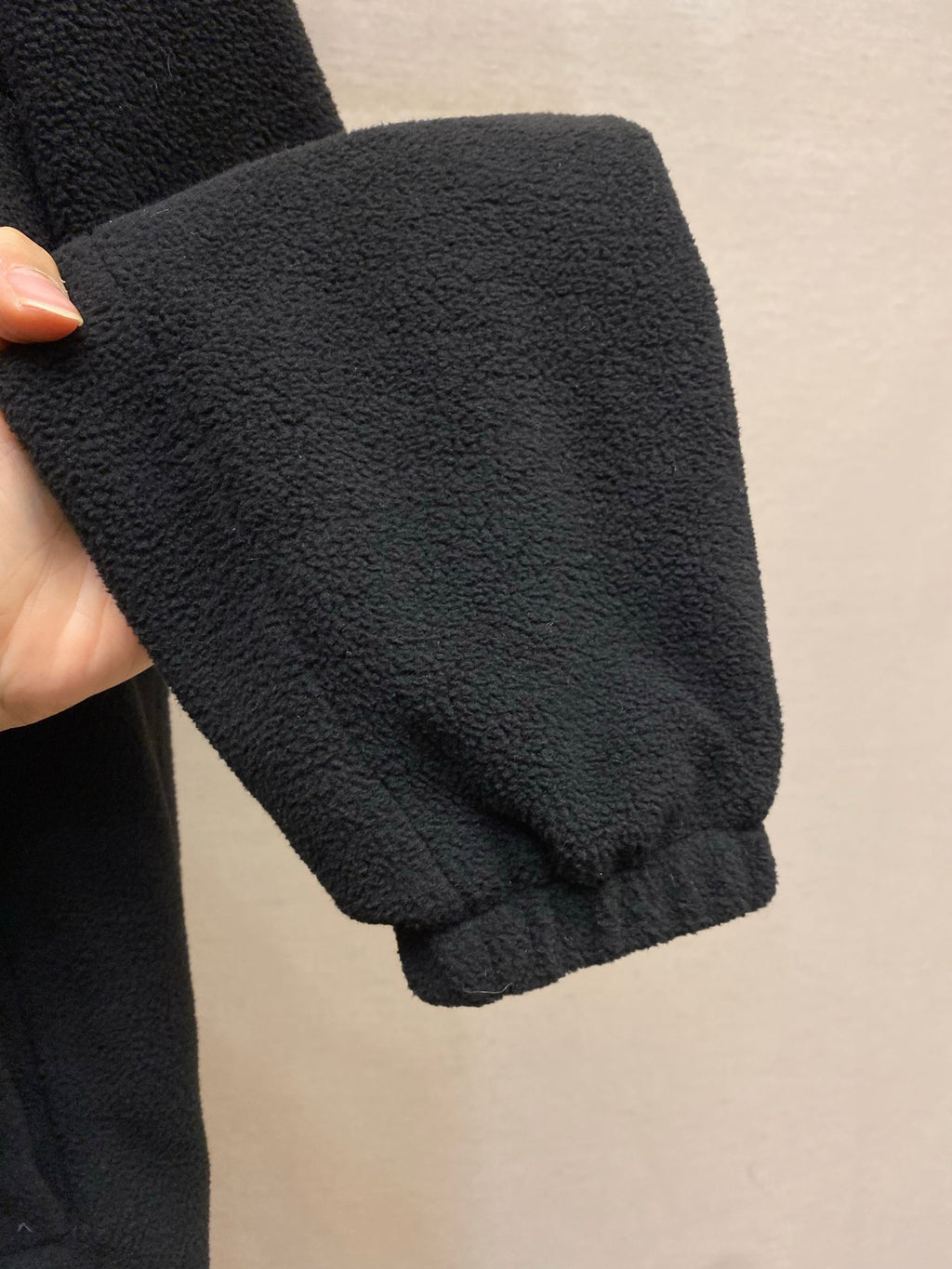 Prada jacket sleeve cuff in dark textured fleece, close-up