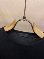 Crewneck knit sweater neckline with inner brand label on hanger
