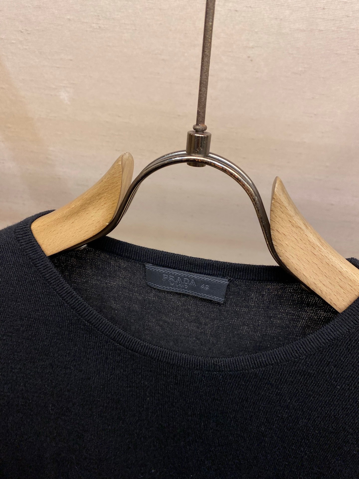 Crewneck knit sweater neckline with inner brand label on hanger