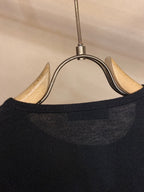 Sweater collar ribbing close-up on hanger in dark knit