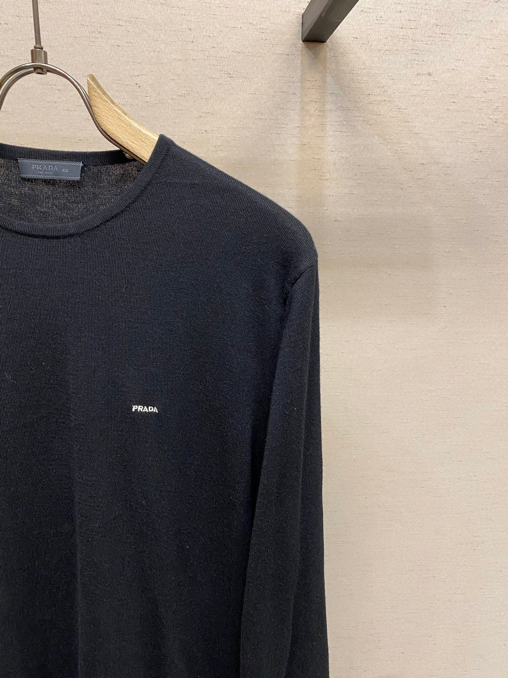 Prada crewneck sweater close-up with small PRADA logo at chest