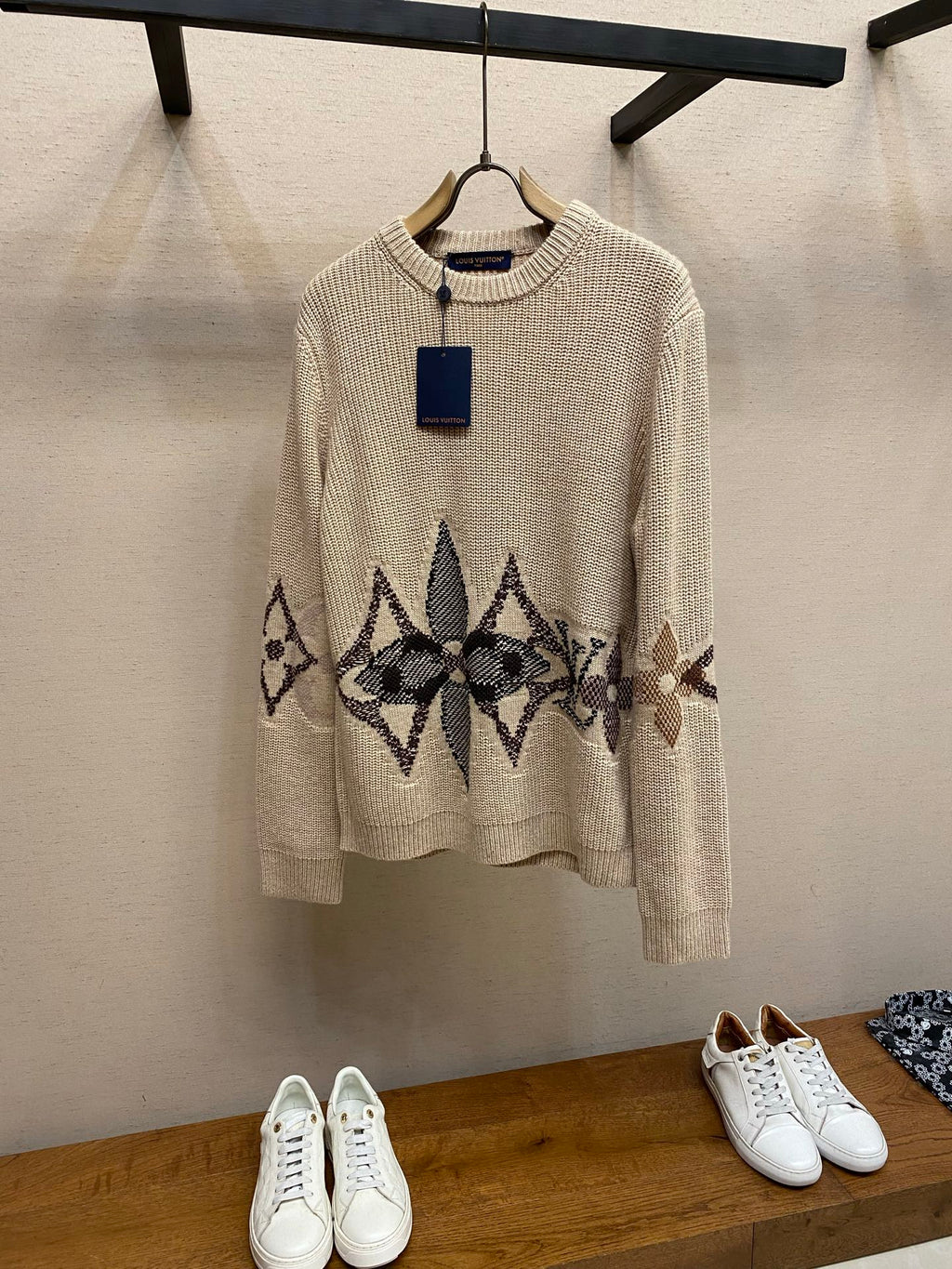 Cream knit crewneck sweater with long sleeves and dark jacquard band graphic