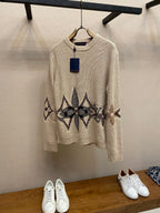 Cream knit crewneck sweater with long sleeves and dark jacquard band graphic