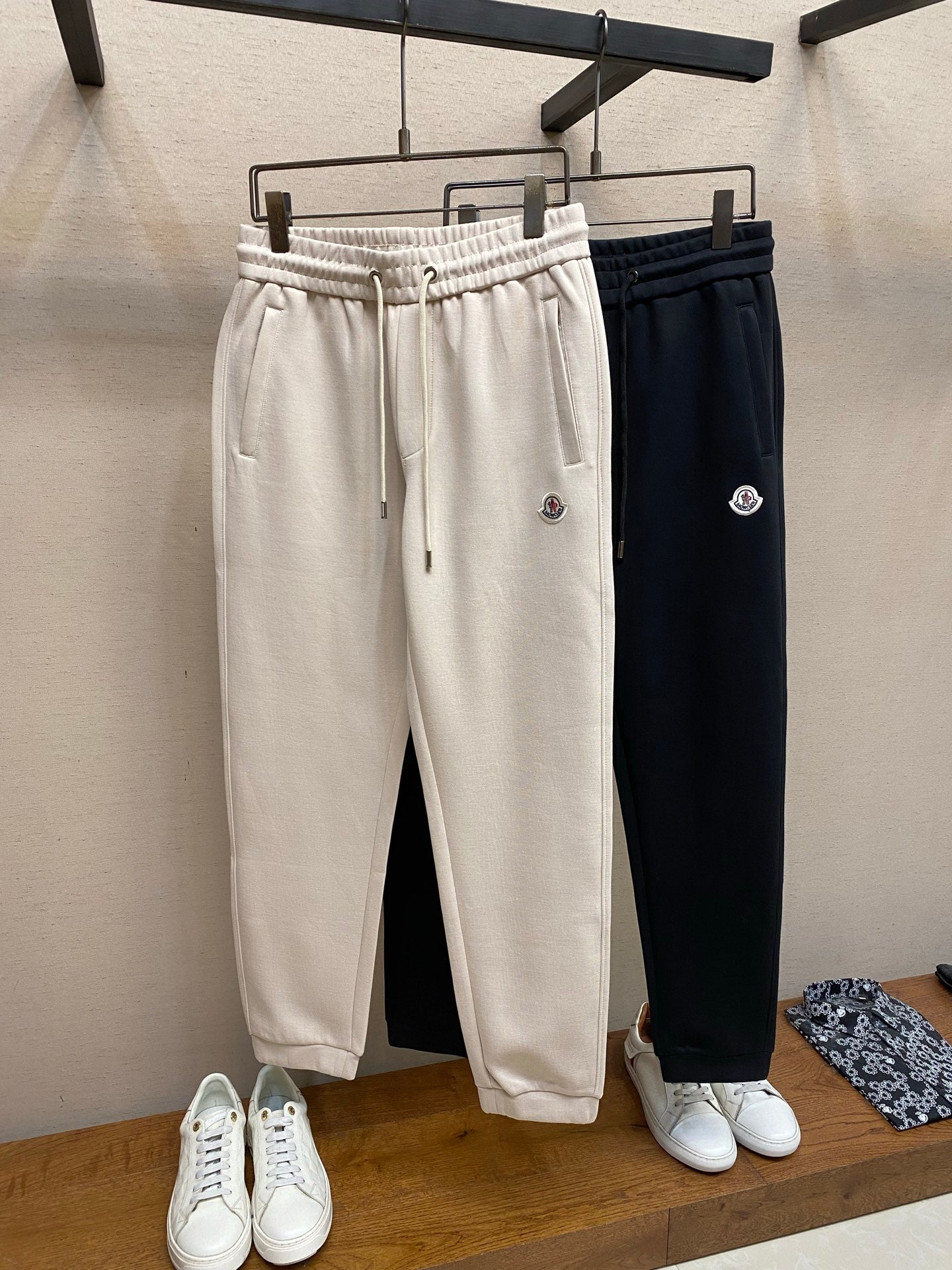 Dark navy Moncler track pants with elastic waistband, drawstring, side logo
