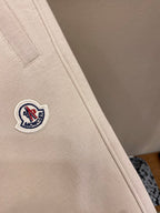 Cream pants leg with small Moncler crest logo patch on side seam