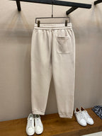 Cream Moncler track pants with elastic cuffs, drawstring waist and side pocket